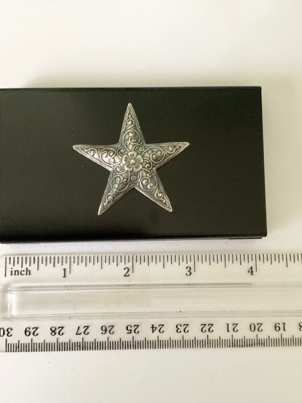 Black metal case accented with ornate silver star. One of a kind, hand crafted.